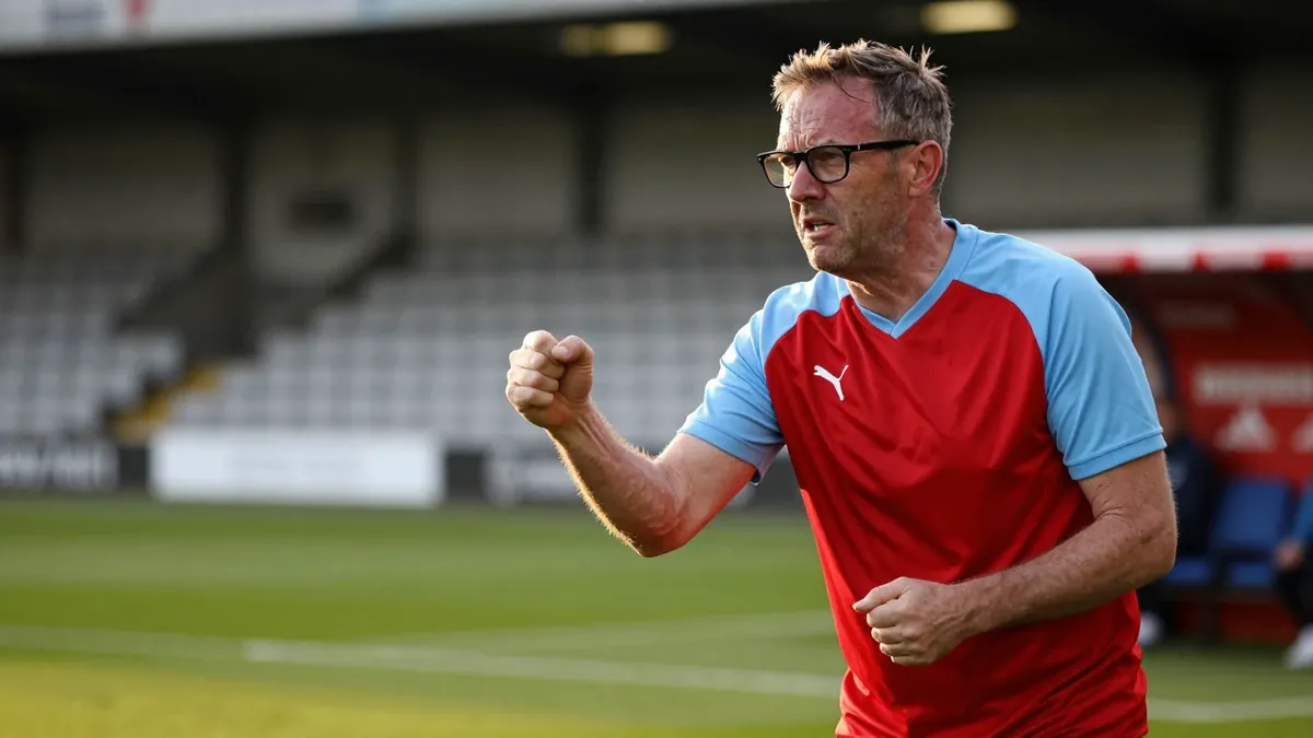 A 35-year-old, ruggedly-built, bespectacled assistant coach of Derry City, dressed in a plain red and sky blue polyester...
